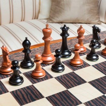 1849 Staunton ebony and antiqued boxwood pieces set up on the 60 cm Andalucia board