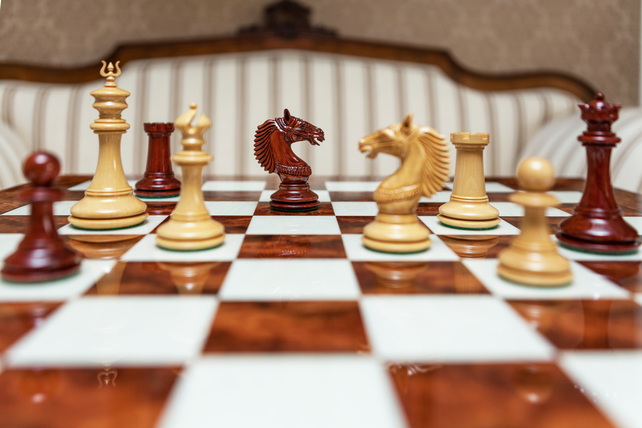 The Apollo chess pieces (Lacquered Padauk and Boxwood) on the 60 cm Da Vinci board The Apollo Series 4.4 inches Chessmen in Lacquered Padauk and Boxwood