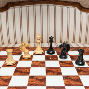 Shown with: 60 cm Da Vinci chess board Wide view of Apollo lacquered ebony and boxwood chess pieces during play on the 60 cm Da Vinci chess board