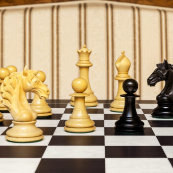 Close-up of Florence boxwood and ebony pieces on the Asturias board