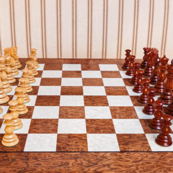 Dali padauk and boxwood pieces in their starting positions on the Segovia board