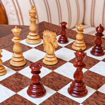 Dali padauk and boxwood pieces in a game position on the Segovia board