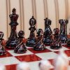 New York Series Chess Pieces on the red 51 cm ”Bologna” Chess Board