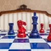 Earl Navy Blue and Red chessmen on the 51 cm Capri board Navy blue and red Earl chessmen on a blue board