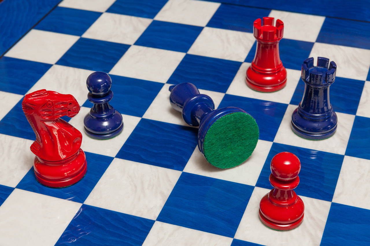 Navy Blue and Red Earl chessmen on a blue board