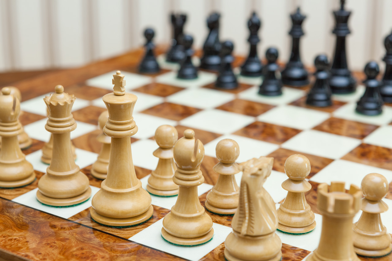 Saga chess set with a root of elm board