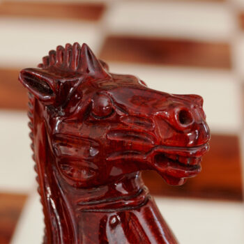 Close-up of a carved Staunton Evolution knight in lacquered padauk