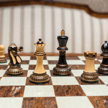 Vulcan burnt boxwood pieces arranged for play on the Cordoba board