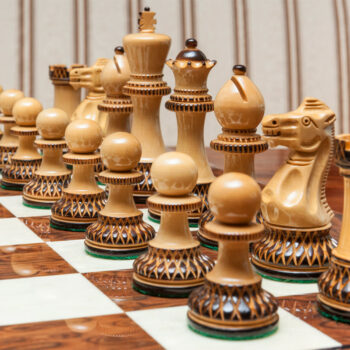 Close-up of the light burnt boxwood Vulcan pieces on the Cordoba board