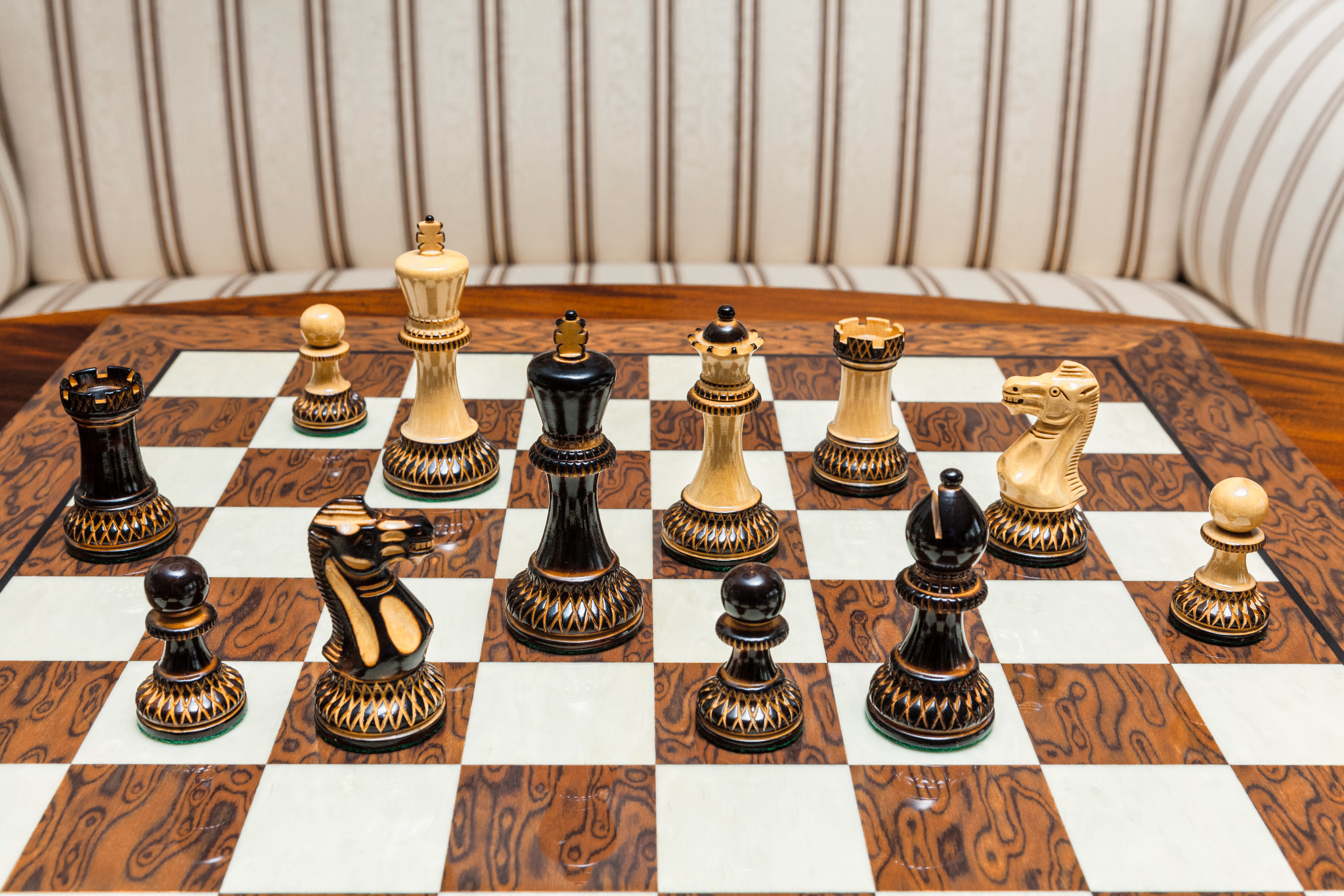 Shown with: 50 cm Cordoba chess board Vulcan burnt boxwood and natural boxwood chess pieces during play on the 50 cm Cordoba chess board