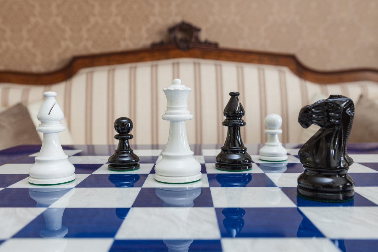 Black and White Earl chessmen on a blue board