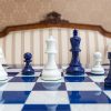 Earl Navy Blue and White chessmen on the 51 cm Capri board Navy Blue and White Earl chessmen on a blue board